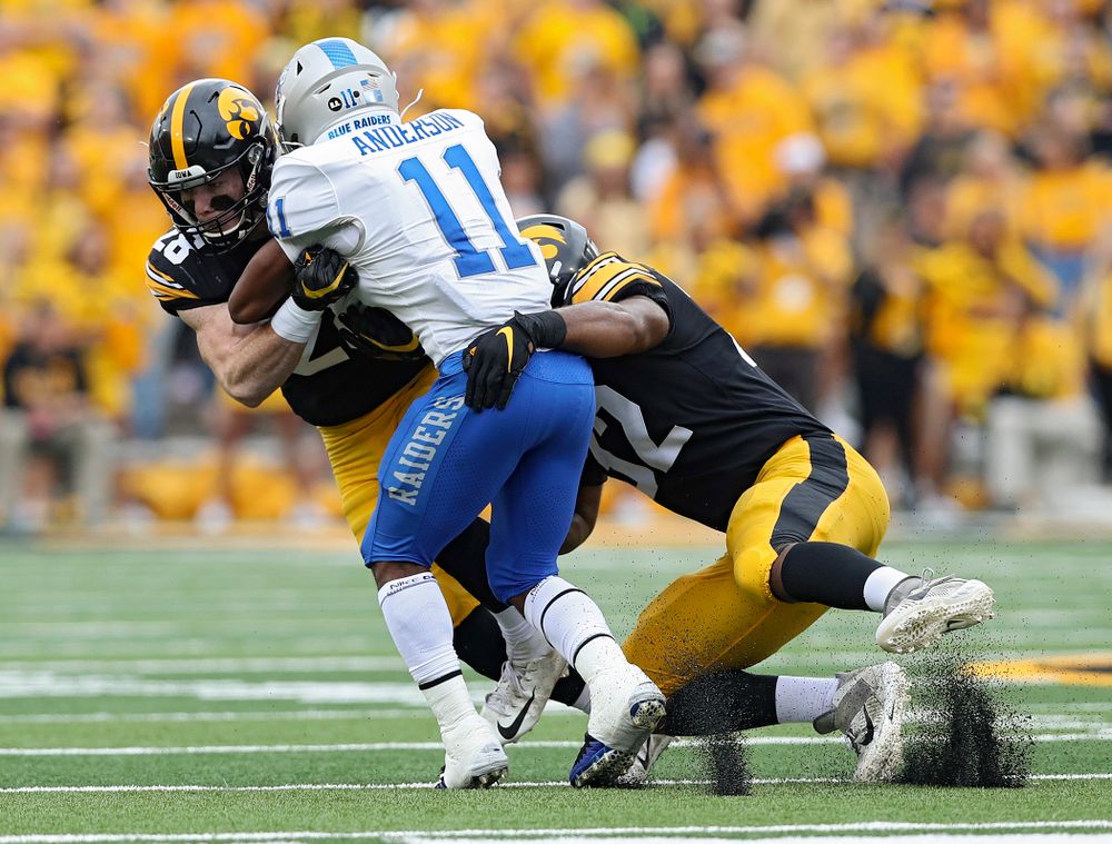 Iowa Hawkeyes defensive back Jack Koerner (28) and Iowa Hawkeyes linebacker Djimon Colbert (32) make a hit during third quarter of their game at Kinnick Stadium in Iowa City on Saturday, Sep 28, 2019. (Stephen Mally/hawkeyesports.com)