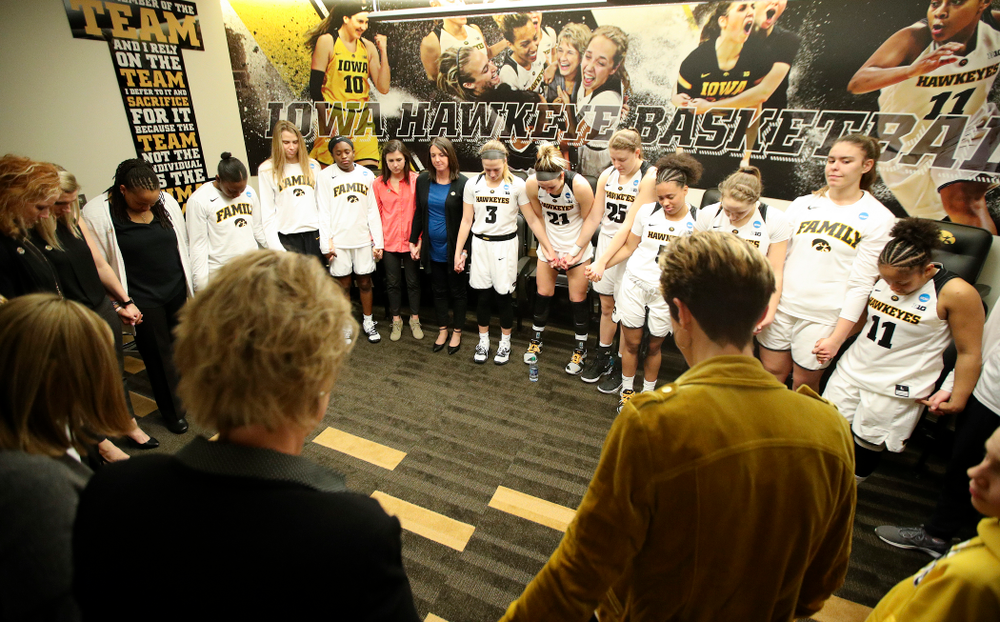 The Iowa Hawkeyes pray as a team in the locker room after winning their second round game in the 2019 NCAA Women's Basketball Tournament at Carver Hawkeye Arena in Iowa City on Sunday, Mar. 24, 2019. (Stephen Mally for hawkeyesports.com)