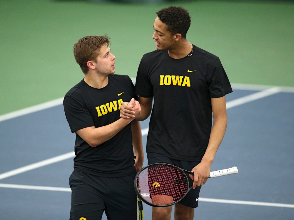 Iowa’s Will Davies (from left) and Oliver Okonkwo celebrate after winning their doubles match at the Hawkeye Tennis and Recreation Complex in Iowa City on Friday, March 6, 2020. (Stephen Mally/hawkeyesports.com)