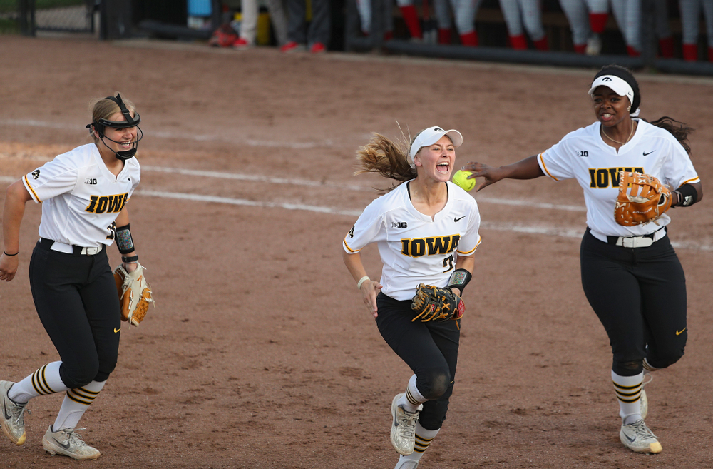 Iowa second baseman Aralee Bogar (center) shouts as she runs back to the dugout with pitcher Sarah Lehman (left) and first baseman DoniRae Mayhew (right) after they turned an inning ending double play during the sixth inning of their game against Ohio State at Pearl Field in Iowa City on Friday, May. 3, 2019. (Stephen Mally/hawkeyesports.com)
