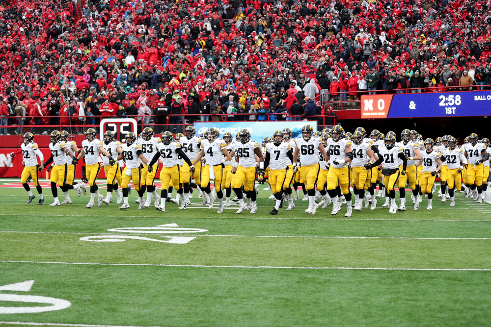 The Iowa Hawkeyes swarm onto the field against the Nebraska Cornhuskers Friday, November 29, 2019 at Memorial Stadium in Lincoln, Neb. (Brian Ray/hawkeyesports.com)