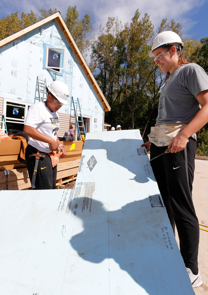 Iowa Hawkeyes guard Tania Davis (11) and forward/center Paula Valino Ramos (31) work on the Habitat for Humanity Women's Build Wednesday, September 26, 2018 in Iowa City. (Brian Ray/hawkeyesports.com)