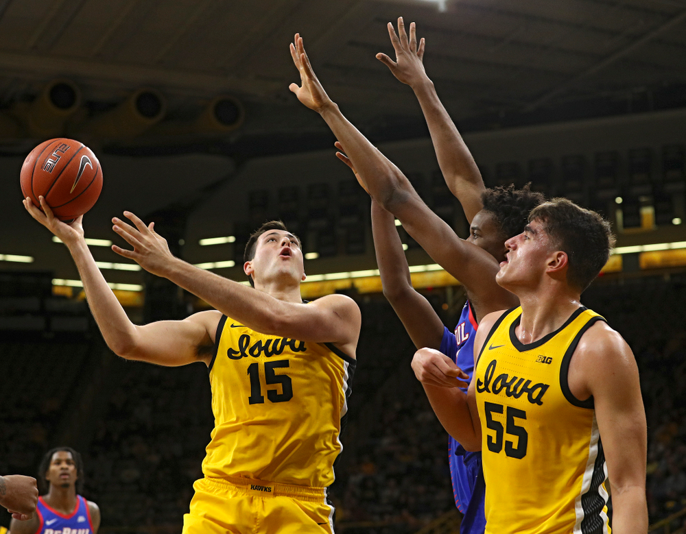 Iowa Hawkeyes forward Ryan Kriener (15) puts up a shot as center Luka Garza (55) looks on during the first half of their game at Carver-Hawkeye Arena in Iowa City on Monday, Nov 11, 2019. (Stephen Mally/hawkeyesports.com)