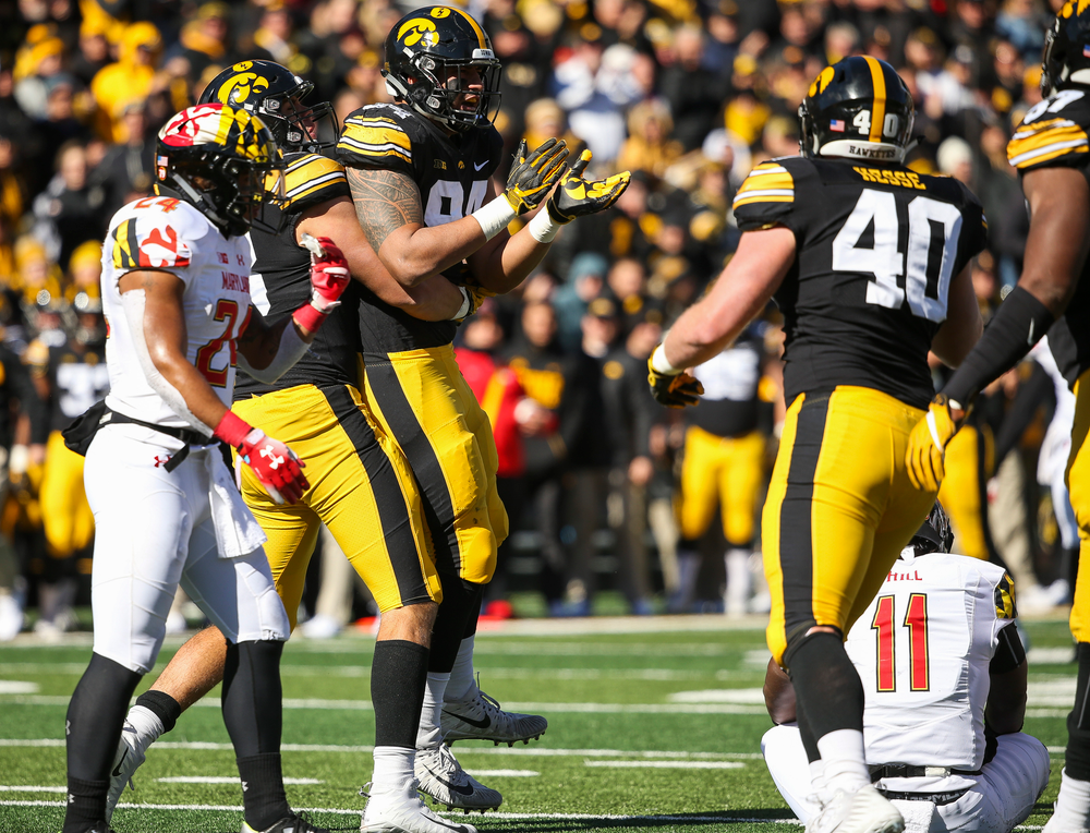 Iowa Hawkeyes defensive end Anthony Nelson (98) and Iowa Hawkeyes defensive end A.J. Epenesa (94) react after Epenesa's sack during a game against Maryland at Kinnick Stadium on October 20, 2018. (Tork Mason/hawkeyesports.com)