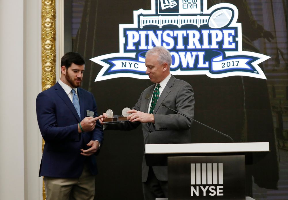 Iowa Hawkeyes linebacker Josey Jewell (43), defensive back Joshua Jackson (15), offensive lineman Sean Welsh (79) and head coach Kirk Ferentz ring the opening bell at the New York Stock Exchange Tuesday, December 26, 2017 in New York. (Brian Ray/hawkeyesports.com)
