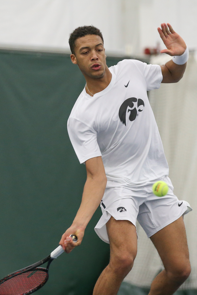 Iowa’s Oliver Okonkwo returns a hit during the Iowa men’s tennis meet vs Nebraska on Sunday, March 1, 2020 at the Hawkeye Tennis and Recreation Complex. (Lily Smith/hawkeyesports.com)