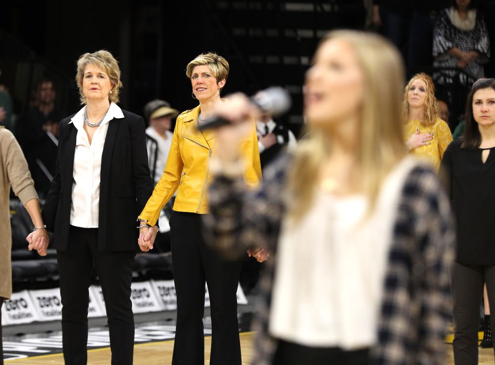 Iowa Hawkeyes head coach Lisa Bluder watches as her daughter Emma sings the National Anthem before the Iowa Hawkeyes game against the Northwestern Wildcats Sunday, March 3, 2019 at Carver-Hawkeye Arena. (Brian Ray/hawkeyesports.com)