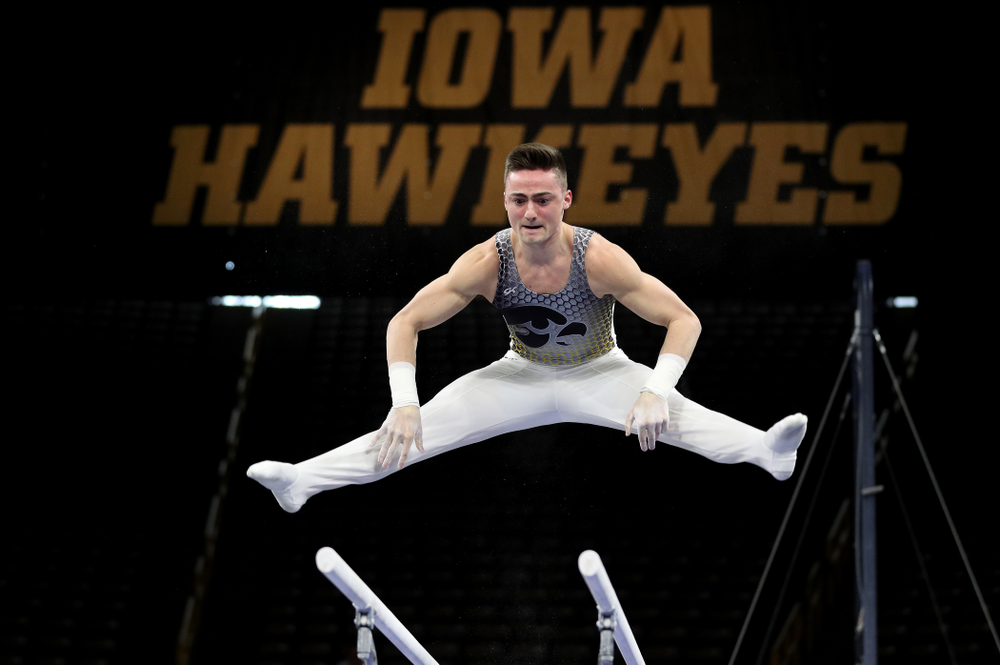 Iowa’s Mitch Mandozzi competes on the parallel bars against Illinois Sunday, March 1, 2020 at Carver-Hawkeye Arena. (Brian Ray/hawkeyesports.com)