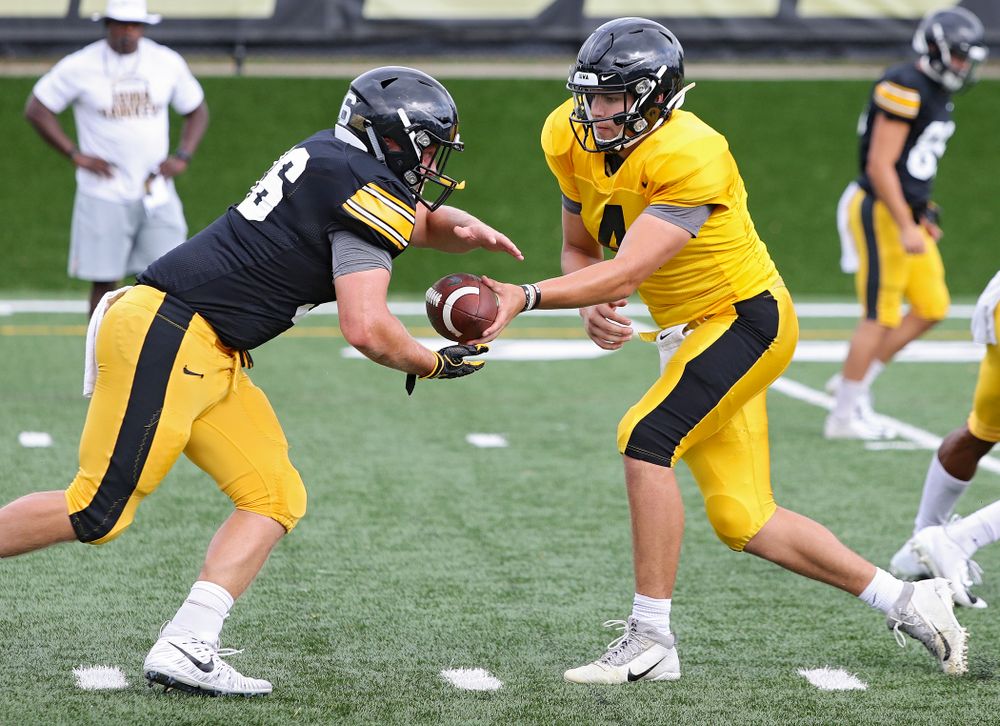 Iowa Hawkeyes quarterback Nate Stanley (4) hands the ball off to fullback Brady Ross (36) during Fall Camp Practice No. 10 at the Hansen Football Performance Center in Iowa City on Tuesday, Aug 13, 2019. (Stephen Mally/hawkeyesports.com)