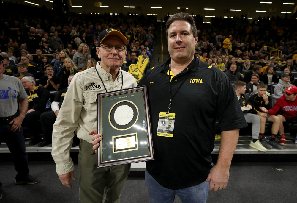 Legendary former head coach Dan Gable presents Mark Reiland with the National Wrestling Hall of Fame Lifetime Service to Wrestling Award during the Iowa Hawkeyes dual against Oklahoma State Sunday, February 23, 2020 at Carver-Hawkeye Arena. (Brian Ray/hawkeyesports.com)