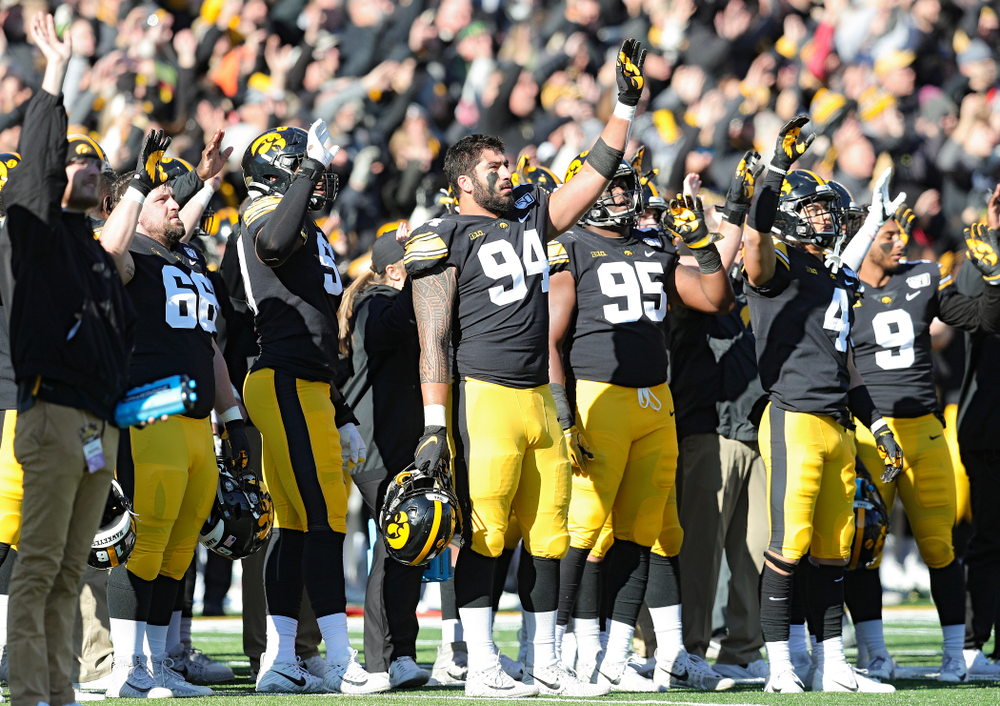 Iowa Hawkeyes defensive end A.J. Epenesa (94) and teammates wave to the University of Iowa Stead Family Children's Hospital between the first and second quarter of their game at Kinnick Stadium in Iowa City on Saturday, Nov 23, 2019. (Stephen Mally/hawkeyesports.com)