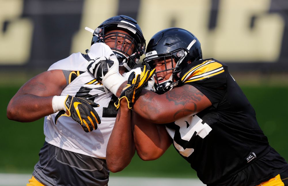 Iowa Hawkeyes defensive end Chauncey Golston (57) and offensive lineman Tristan Wirfs (74) during camp practice No. 16 Tuesday, August 21, 2018 at the Hansen Football Performance Center. (Brian Ray/hawkeyesports.com)