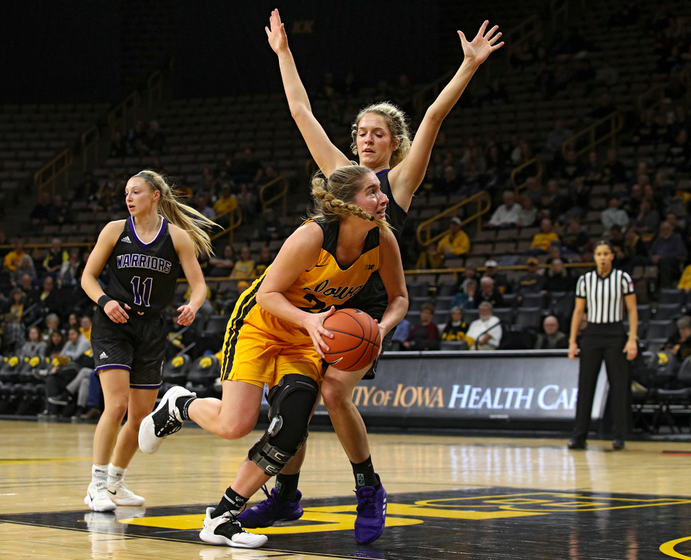 Iowa guard Kate Martin (20) is fouled as she drives in during the first quarter of their game against Winona State at Carver-Hawkeye Arena in Iowa City on Sunday, Nov 3, 2019. (Stephen Mally/hawkeyesports.com)