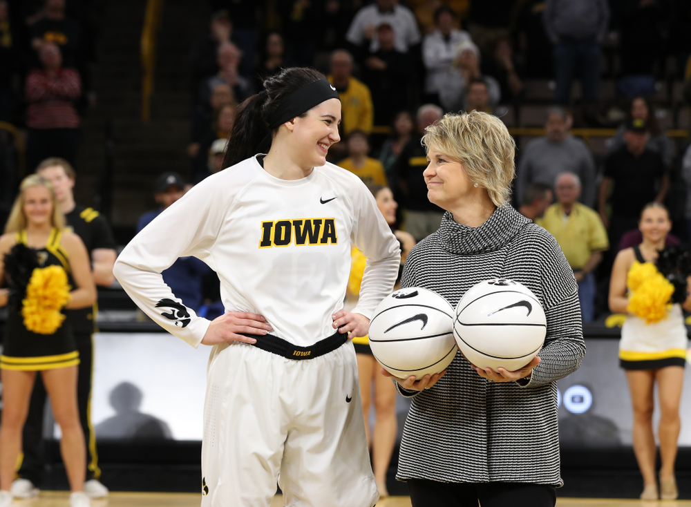 Iowa Hawkeyes forward Megan Gustafson (10) receives a pair of commemorative basketballs from head coach Lisa Bluder for becoming the school's all time rebounds leader and scoring leader before their gam eagainst the Nebraska Cornhuskers Thursday, January 3, 2019 at Carver-Hawkeye Arena. (Brian Ray/hawkeyesports.com)