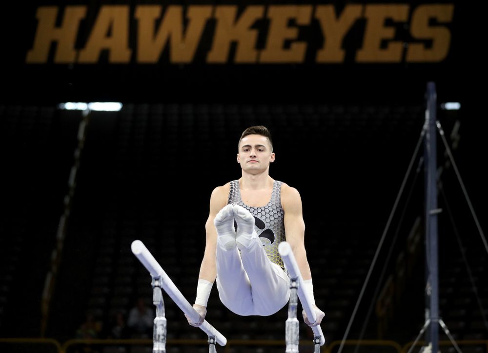 Iowa’s Mitch Mandozzi competes on the parallel bars against Illinois Sunday, March 1, 2020 at Carver-Hawkeye Arena. (Brian Ray/hawkeyesports.com)