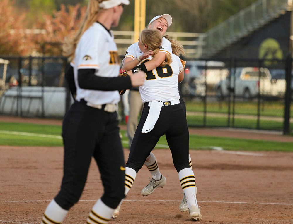 Iowa second baseman Aralee Bogar (2) jumps into the arms of pitcher Sarah Lehman (16) after winning their game against Ohio State at Pearl Field in Iowa City on Friday, May. 3, 2019. (Stephen Mally/hawkeyesports.com)