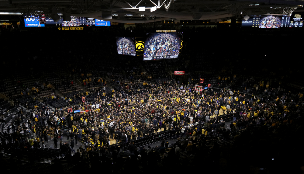 Fans storm the court after Iowa Hawkeyes defeated the Michigan Wolverines Friday, February 1, 2019 at Carver-Hawkeye Arena. (Brian Ray/hawkeyesports.com)
