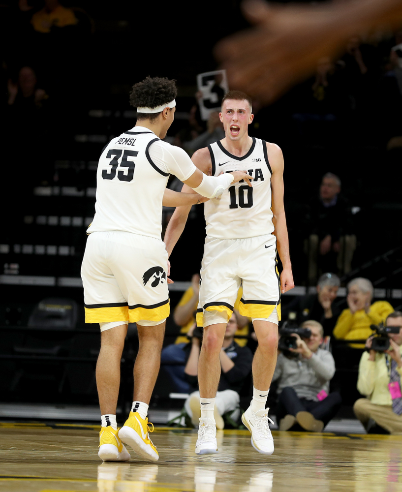 Iowa Hawkeyes guard Joe Wieskamp (10) celebrates a three point basket with forward Cordell Pemsl (35) against the Maryland Terrapins Friday, January 10, 2020 at Carver-Hawkeye Arena. (Brian Ray/hawkeyesports.com)