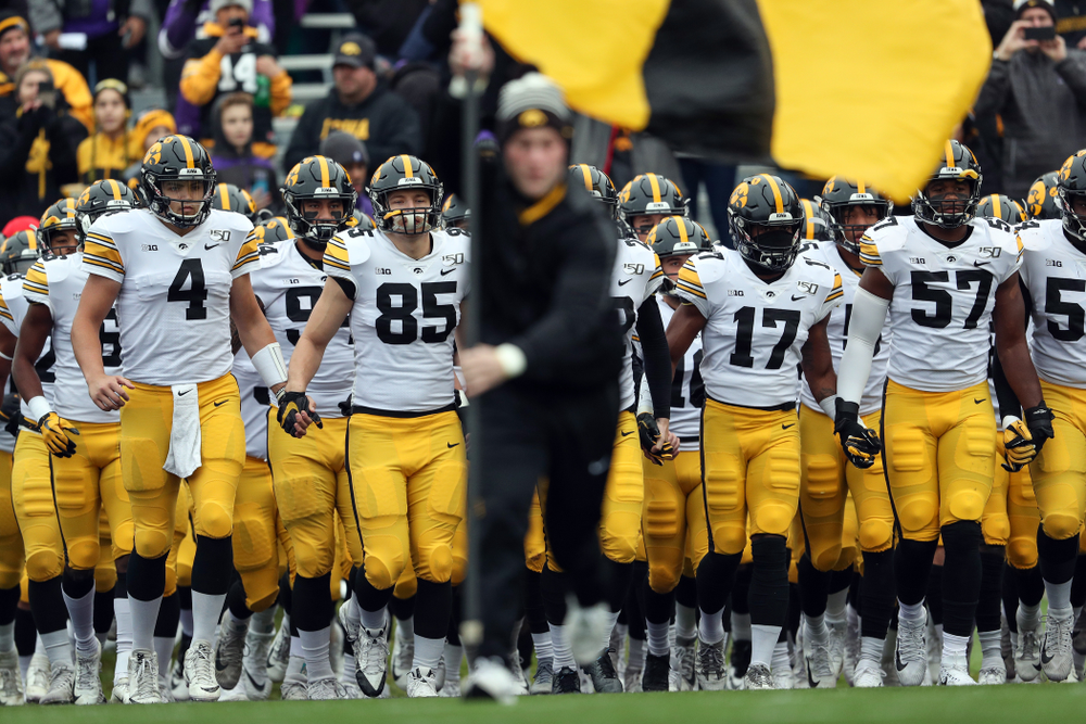 The Iowa Hawkeyes swarm the field against the Northwestern Wildcats Saturday, October 26, 2019 at Ryan Field in Evanston, Ill. (Brian Ray/hawkeyesports.com)