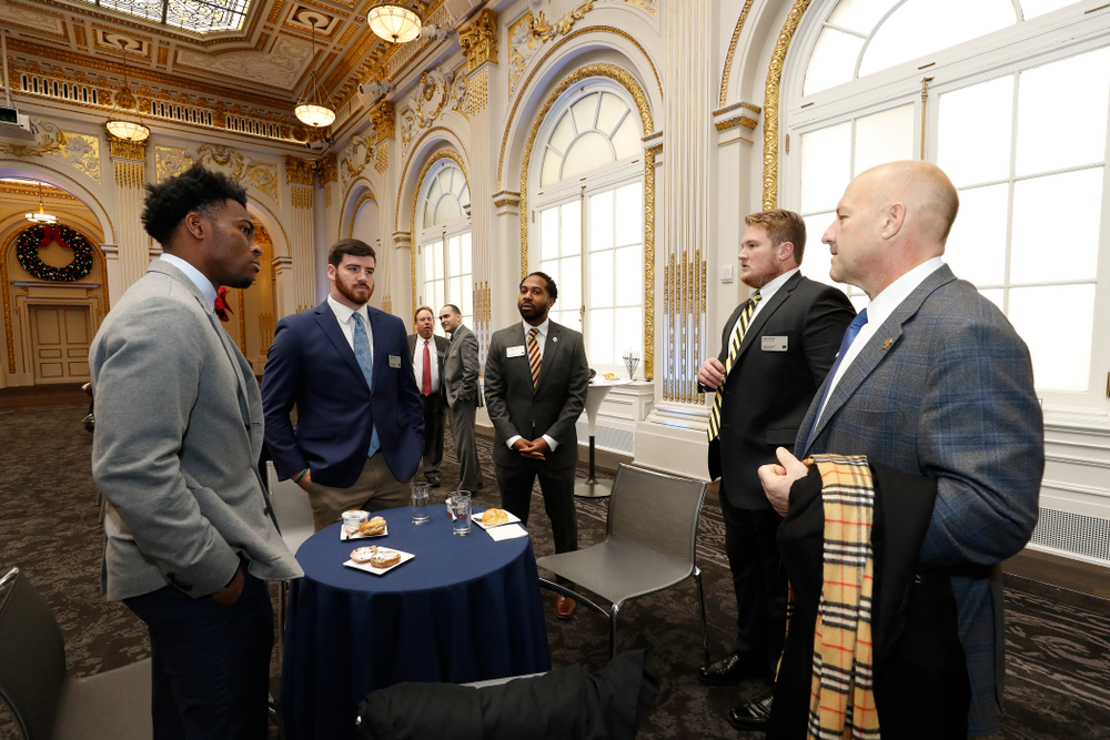 Iowa Hawkeyes linebacker Josey Jewell (43), defensive back Joshua Jackson (15), offensive lineman Sean Welsh (79) and head coach Kirk Ferentz ring the opening bell at the New York Stock Exchange Tuesday, December 26, 2017 in New York. (Brian Ray/hawkeyesports.com)