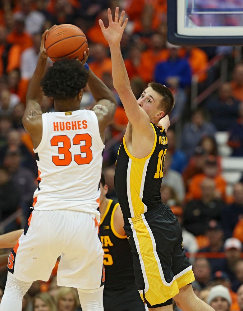 Iowa Hawkeyes guard Joe Wieskamp (10) tries to block a shot by Syracuse Orange forward Elijah Hughes (33) during the first half of their ACC/Big Ten Challenge game at the Carrier Dome in Syracuse, N.Y. on Tuesday, Dec 3, 2019. (Stephen Mally/hawkeyesports.com)
