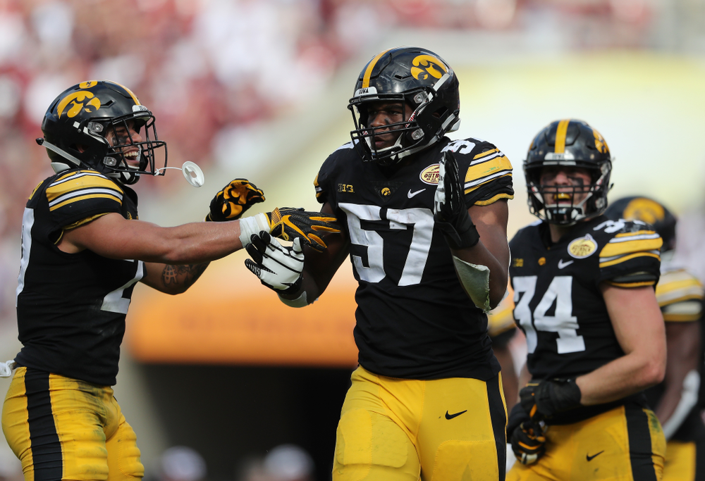 Iowa Hawkeyes defensive end Chauncey Golston (57) celebrates with defensive back Amani Hooker (27) after intercepting a pass during the Outback Bowl Tuesday, January 1, 2019 at Raymond James Stadium in Tampa, FL. (Brian Ray/hawkeyesports.com)