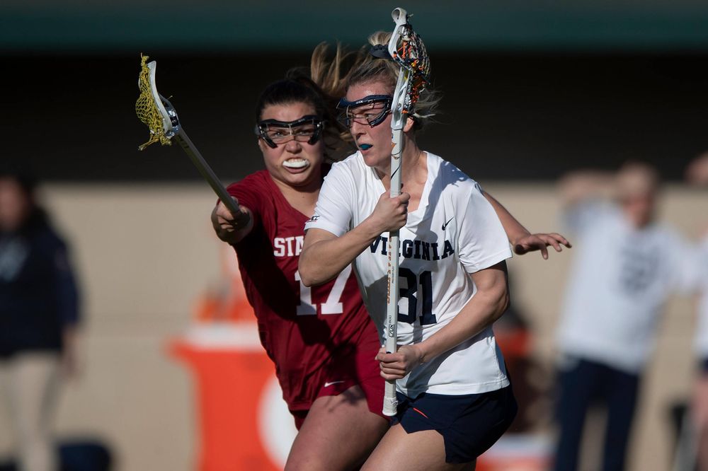STANFORD, California - FEBRUARY 14: Virginia Cavaliers defense Ashley Stilo (31) is defended by Stanford Cardinal attack Katherine Gjertsen (17) during the first half at Cagan Stadium on February 14, 2020 in Stanford, California. The Virginia Cavaliers defeated the Stanford Cardinal 12-11. (Photo by Jason O. Watson)