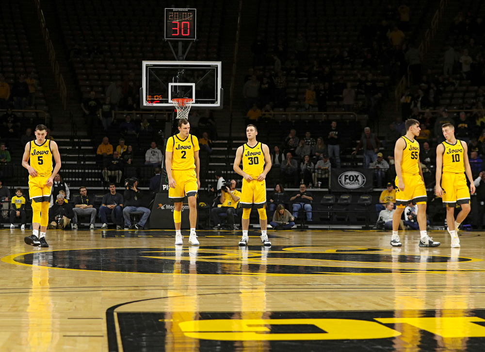 Iowa Hawkeyes guard CJ Fredrick (5), forward Jack Nunge (2), guard Connor McCaffery (30), center Luka Garza (55), and guard Joe Wieskamp (10) walk on the court before their game at Carver-Hawkeye Arena in Iowa City on Monday, Nov 11, 2019. (Stephen Mally/hawkeyesports.com)