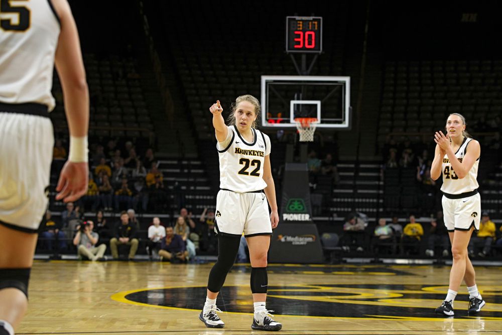Iowa Hawkeyes guard Kathleen Doyle (22) points to forward Monika Czinano (25) after she made a basket while being fouled as forward Amanda Ollinger (43) claps during the second quarter of the game at Carver-Hawkeye Arena in Iowa City on Thursday, February 6, 2020. (Stephen Mally/hawkeyesports.com)