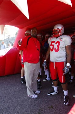 Lobo head coach Mike Locksley talks with Kendall Briscoe before the Cherry-Silver Spring game.