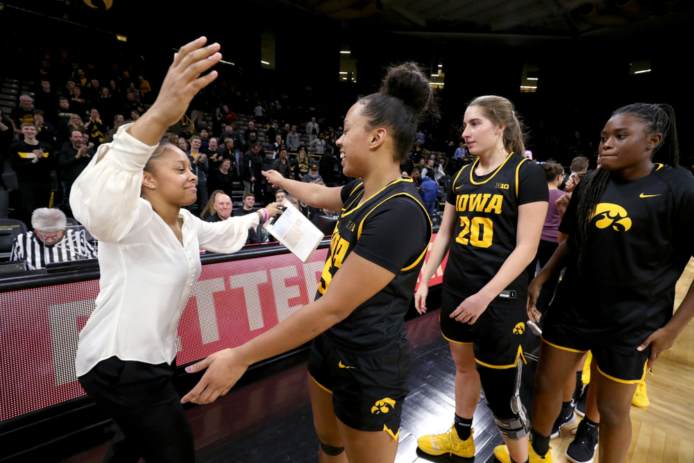 Iowa Hawkeyes guard Alexis Sevillian (5) hugs former Hawkeye and Clemson graduate assistant Tania Davis following their game Wednesday, December 4, 2019 at Carver-Hawkeye Arena. (Brian Ray/hawkeyesports.com)