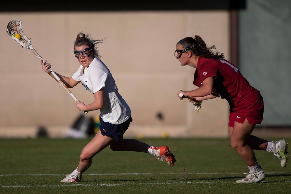 STANFORD, California - FEBRUARY 14: Virginia Cavaliers midfield Courtlynne Caskin (25) is defended by Stanford Cardinal midfield Chelsea Trattner (16) during the second half at Cagan Stadium on February 14, 2020 in Stanford, California. The Virginia Cavaliers defeated the Stanford Cardinal 12-11. (Photo by Jason O. Watson)
