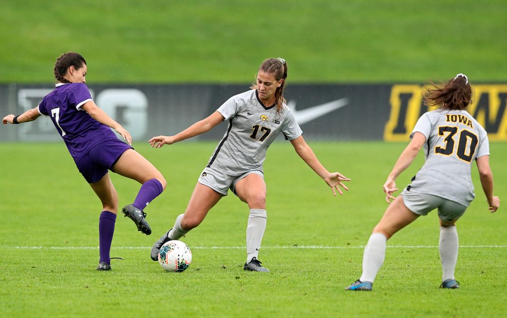 Iowa defender Hannah Drkulec (17) passes the ball as forward Devin Burns (30) looks on during the first half of their match at the Iowa Soccer Complex in Iowa City on Sunday, Sep 29, 2019. (Stephen Mally/hawkeyesports.com)