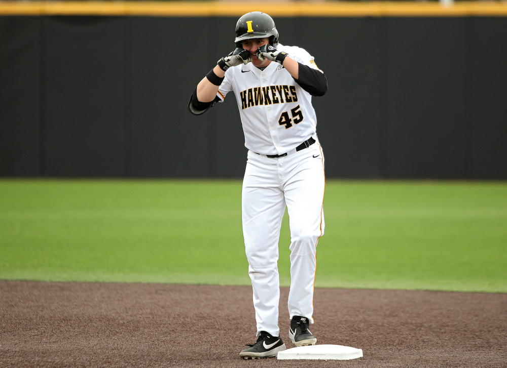 Iowa first baseman Peyton Williams (45) celebrates on second base after hitting a double during the first inning of their college baseball game at Duane Banks Field in Iowa City on Wednesday, March 11, 2020. (Stephen Mally/hawkeyesports.com)