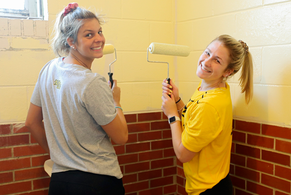 Iowa women's swimming and diving teammates paint a room at the Coralville Community Food Pantry during the 21st annual ISAAC Hawkeye Day of Caring in Coralville on Sunday, Apr. 28, 2019. (Stephen Mally/hawkeyesports.com)