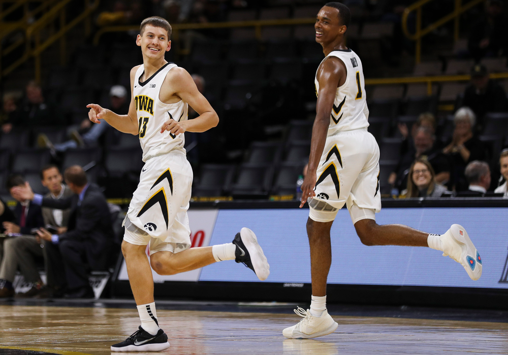 Iowa Hawkeyes guard Austin Ash (13) reacts after making a 3-pointer during a game against Guilford College at Carver-Hawkeye Arena on November 4, 2018. (Tork Mason/hawkeyesports.com)