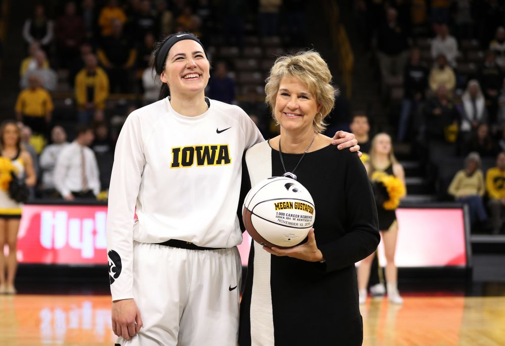 Iowa Hawkeyes forward Megan Gustafson (10) revives a ball commemorating her 1,00th career rebound from Iowa Hawkeyes head coach Lisa Bluder during their game against the IUPUI Jaguars Saturday, December 8, 2018 at Carver-Hawkeye Arena. (Brian Ray/hawkeyesports.com)