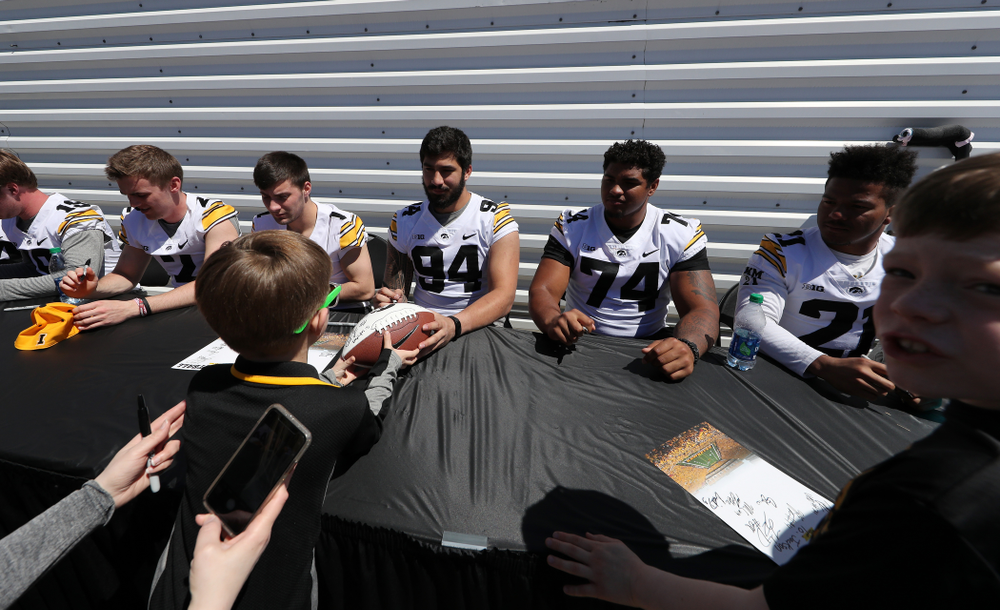 Members of the Iowa Football team sign autographs before the Iowa Hawkeyes game against the Nebraska Cornhuskers Saturday, April 20, 2019 at Duane Banks Field. (Brian Ray/hawkeyesports.com)
