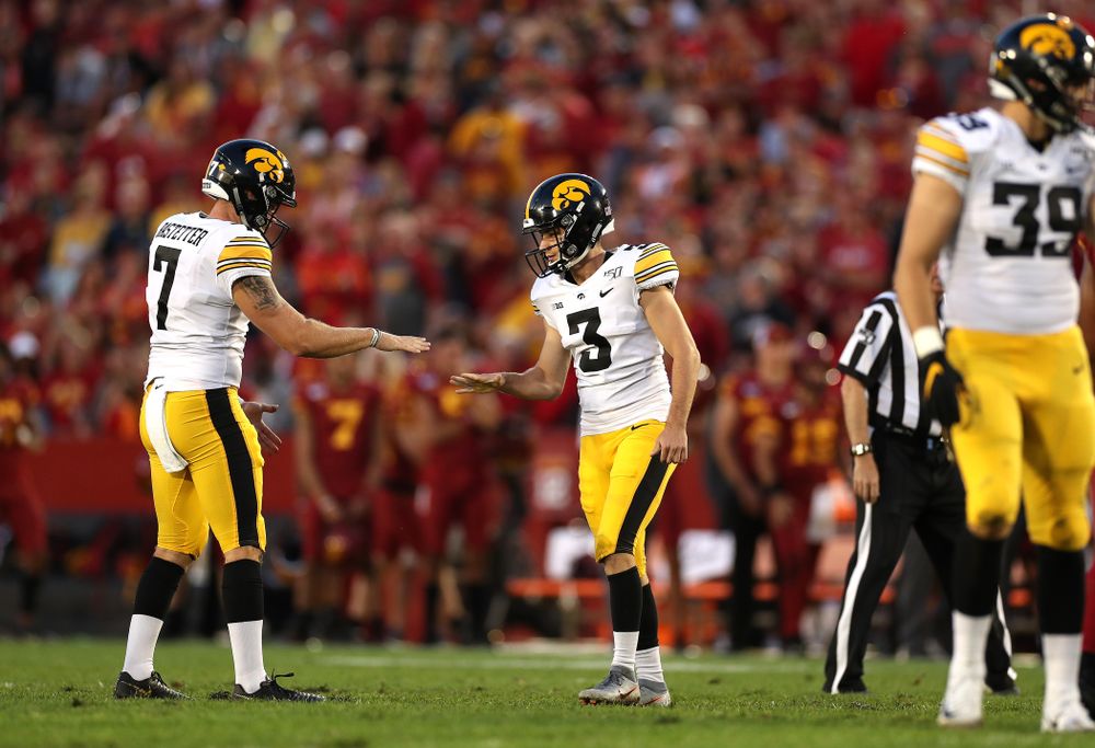 Iowa Hawkeyes place kicker Keith Duncan (3) plays rock, paper, scissors with punter Colten Rastetter (7) following a field goal against the Iowa State Cyclones Saturday, September 14, 2019 in Ames, Iowa. (Brian Ray/hawkeyesports.com)
