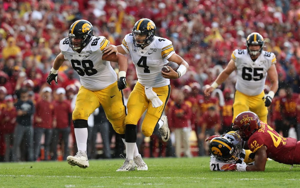 Iowa Hawkeyes quarterback Nate Stanley (4) runs behind offensive lineman Landan Paulsen (68) against the Iowa State Cyclones Saturday, September 14, 2019 at Jack Trice Stadium in Ames, Iowa. (Brian Ray/hawkeyesports.com)
