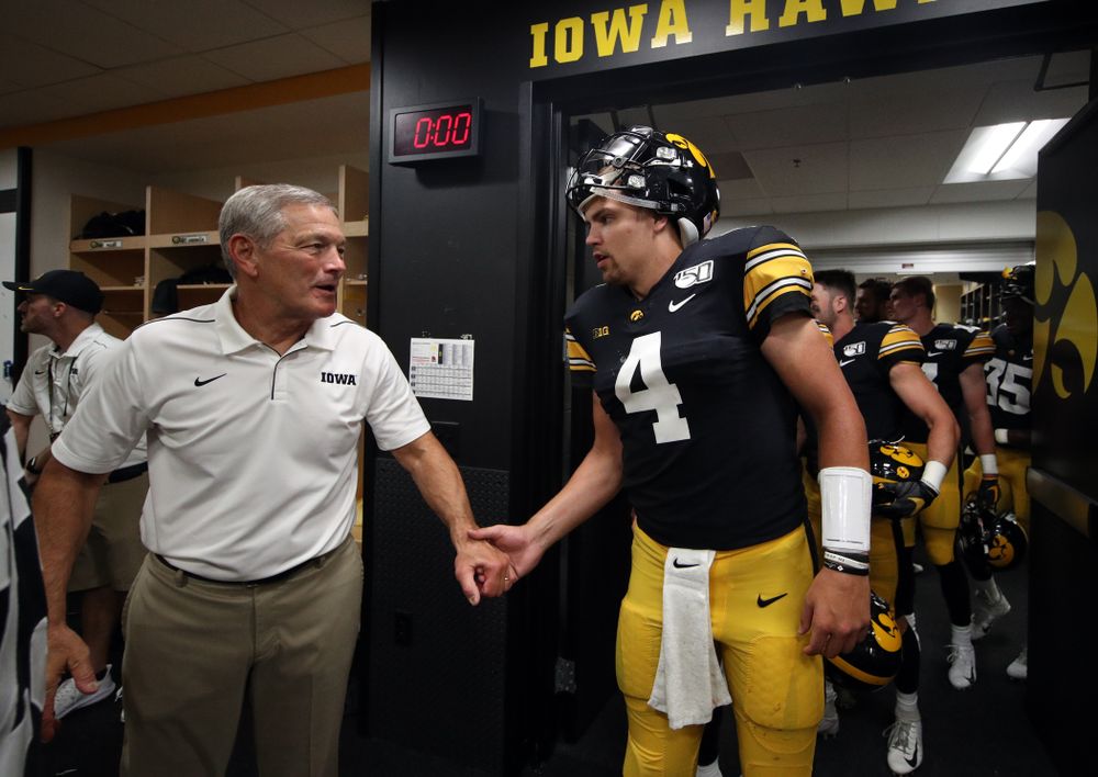 Iowa Hawkeyes head coach Kirk Ferentz congratulates quarterback Nate Stanley (4) following their game against the Miami RedHawks Saturday, August 31, 2019 at Kinnick Stadium in Iowa City. (Brian Ray/hawkeyesports.com)