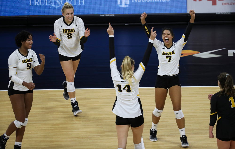 Iowa Hawkeyes middle blocker Amiya Jones (9), Iowa Hawkeyes right side hitter Reghan Coyle (8) and Iowa Hawkeyes setter Brie Orr (7) celebrate after winning a point during a match against Penn State at Carver-Hawkeye Arena on November 3, 2018. (Tork Mason/hawkeyesports.com)