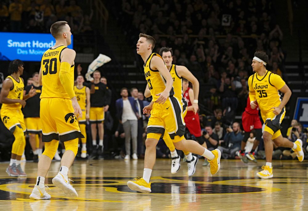 Iowa Hawkeyes guard Austin Ash (13) celebrates after making a 3-pointer during the second half of their game at Carver-Hawkeye Arena in Iowa City on Saturday, February 8, 2020. (Stephen Mally/hawkeyesports.com)