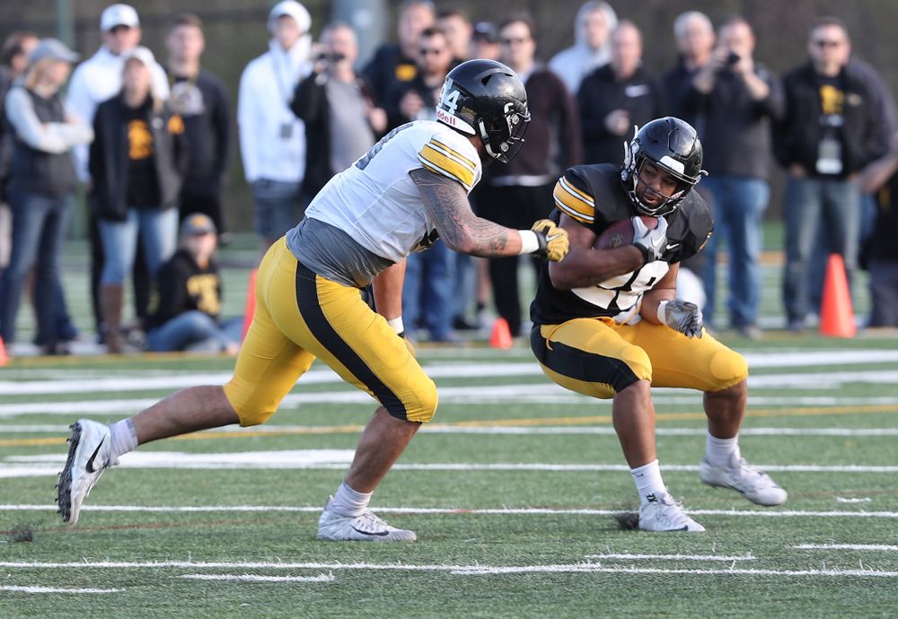 Iowa Hawkeyes running back Toren Young (28) and defensive end A.J. Epenesa (94) during the teamÕs final spring practice Friday, April 26, 2019 at the Kenyon Football Practice Facility. (Brian Ray/hawkeyesports.com)