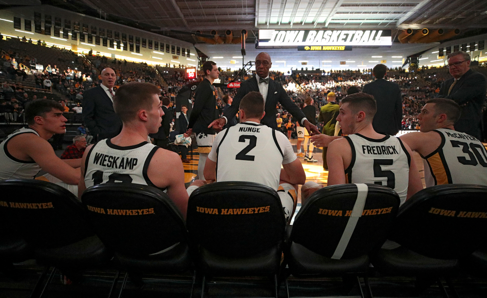 Iowa Hawkeyes assistant coach Sherman Dillard talks with center Luka Garza (55), guard Joe Wieskamp (10), forward Jack Nunge (2), guard CJ Fredrick (5), and guard Connor McCaffery (30) before their game at Carver-Hawkeye Arena in Iowa City on Sunday, Nov 24, 2019. (Stephen Mally/hawkeyesports.com)