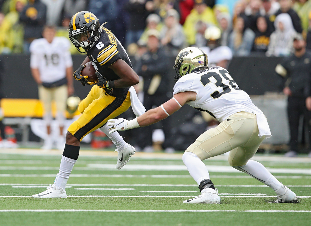 Iowa Hawkeyes wide receiver Ihmir Smith-Marsette (6) spins away from a defender after pulling in a pass during the third quarter of their game at Kinnick Stadium in Iowa City on Saturday, Oct 19, 2019. (Stephen Mally/hawkeyesports.com)