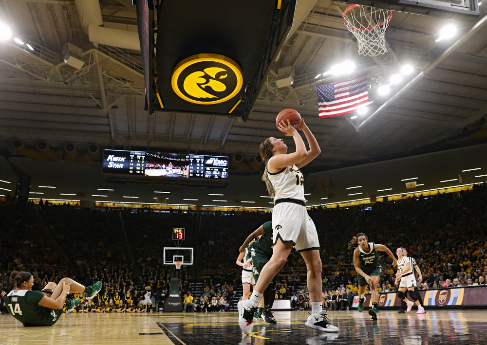 Iowa Hawkeyes guard Mckenna Warnock (14) makes a basket while being fouled during the fourth quarter of their game at Carver-Hawkeye Arena in Iowa City on Sunday, January 26, 2020. (Stephen Mally/hawkeyesports.com)