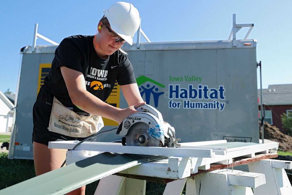 Iowa’s Monika Czinano cuts a piece of siding as they work on a Habitat for Humanity Women Build project in Iowa City on Wednesday, Sep 25, 2019. (Stephen Mally/hawkeyesports.com)