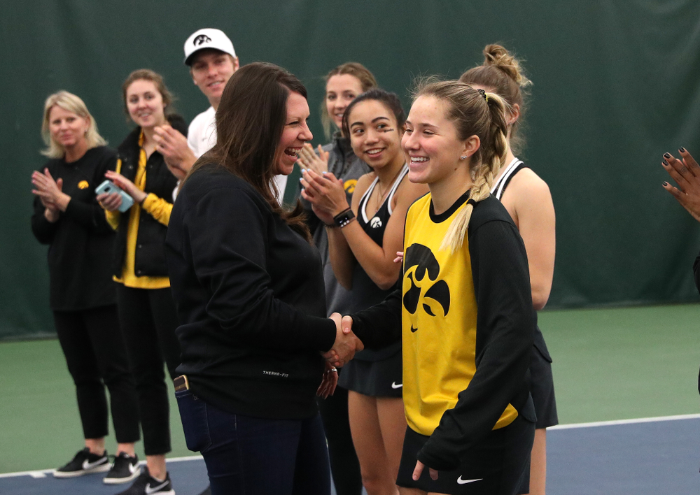 Academic Student Services Associate Director Kara Park congratulates Danielle Burich for earning a 3.0 GPA or better during the fall semester before their match against the Penn State Nittany Lions Sunday, February 24, 2019 at the Hawkeye Tennis and Recreation Complex. (Brian Ray/hawkeyesports.com)