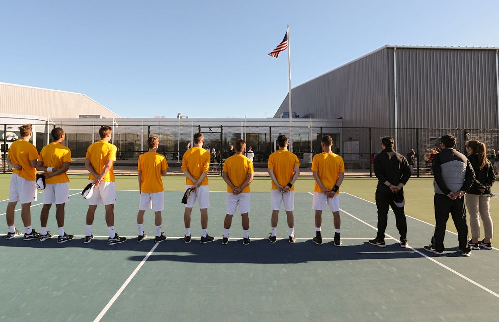 The Iowa Hawkeyes stand for the National Anthem before their match again Michigan State at the Hawkeye Tennis and Recreation Complex in Iowa City on Friday, Apr. 19, 2019. (Stephen Mally/hawkeyesports.com)